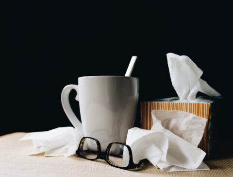 Tisch mit Nastüchern, einer Tasse und einer Brille